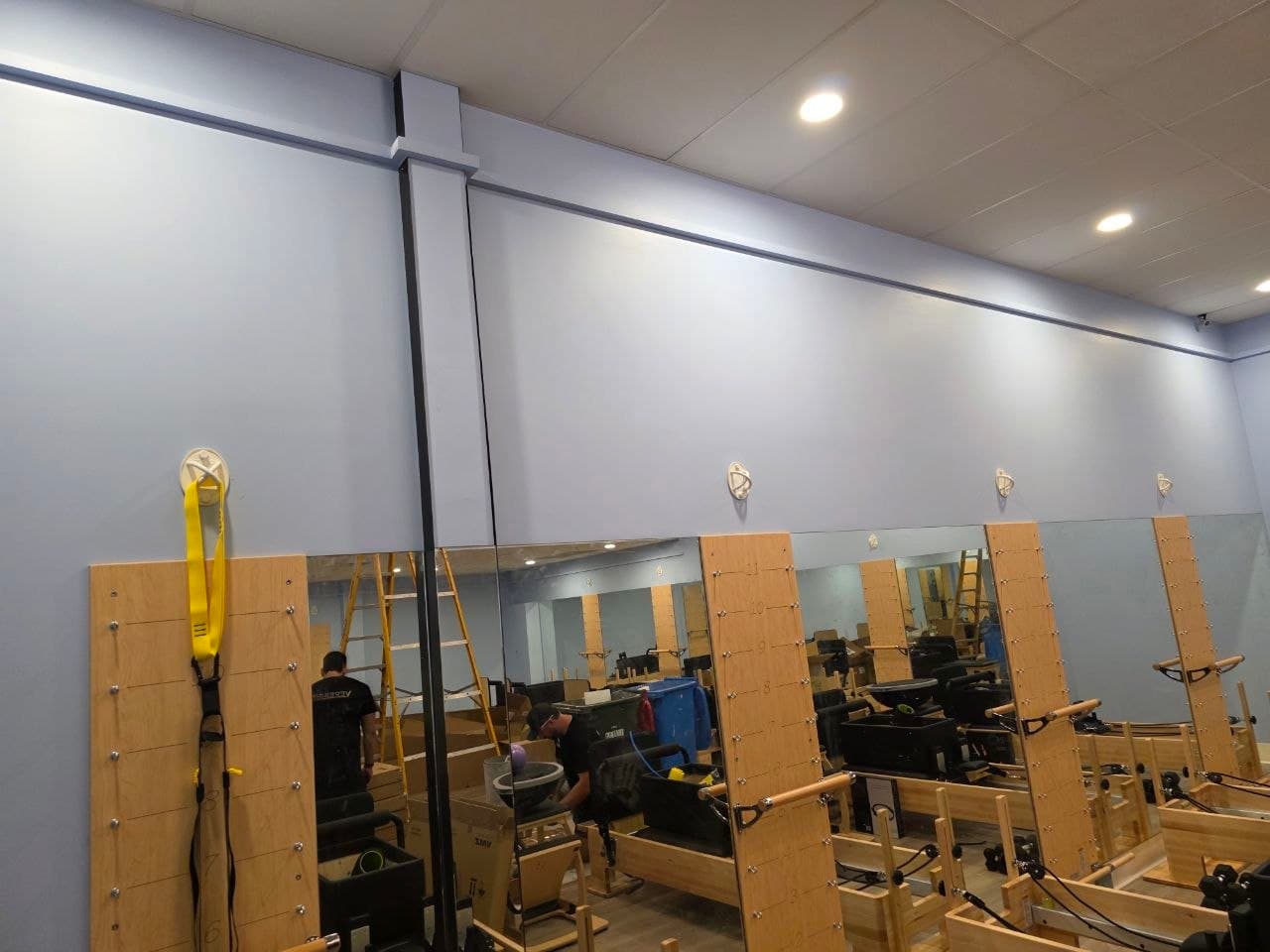 Finished lavender studio wall with mirrors and equipment