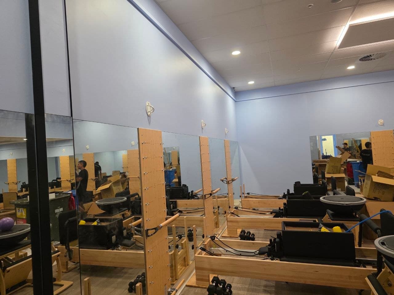 Finished studio walls beside full-height mirrors