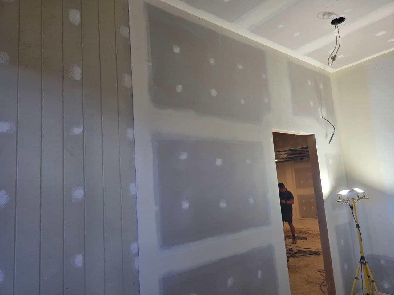 Bare plasterboard walls before painting in the studio