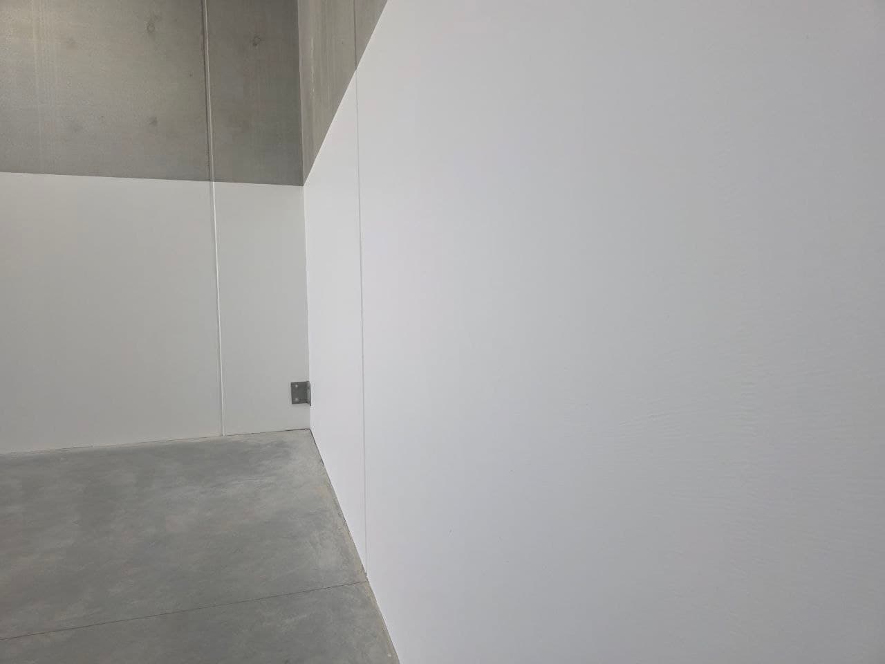 Warehouse walls painted white to dado height